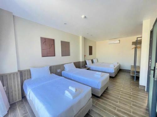 a hotel room with two beds in it at Cham Charm Home Mui Ne in Mui Ne