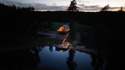 an aerial view of a house in the middle of a lake at Lake view ODYL Holiday House with Sauna and Seasonal Hot-tub in Pindi