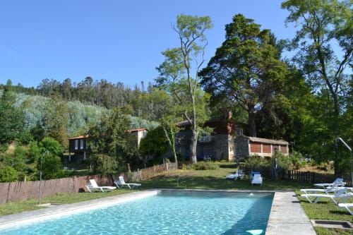 a swimming pool in a yard with a house at Palacio de Barreiro in Crecíente