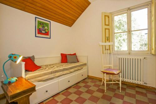 a bedroom with a bed and a table and a window at Villa Leopoldina in Premeno