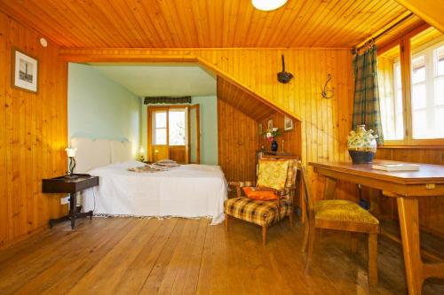 a bedroom with a bed and a desk in a room at Villa Leopoldina in Premeno