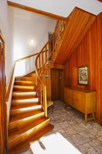 a staircase in a home with wooden walls and wooden floors at Villa Leopoldina in Premeno