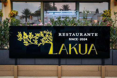 a sign for a restaurant in front of a building at Valentin Star Menorca - Adults Only in Cala'n Bosch