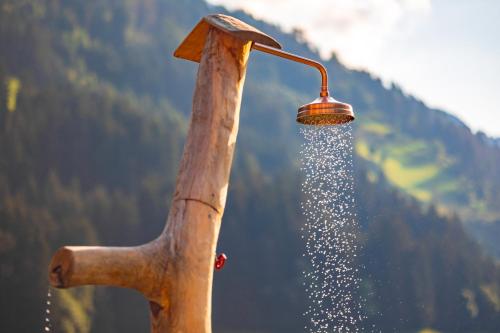 a wooden shower with water coming out of it at Ferienhaus Oberschneider in Selva dei Molini