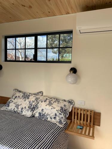 a bedroom with a bed and a window at Forest Retreat Bed and Breakfast in Margaret River Town