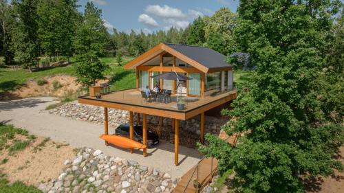 an overhead view of a house with a porch at Lake view ODYL Holiday House with Sauna and Seasonal Hot-tub in Pindi