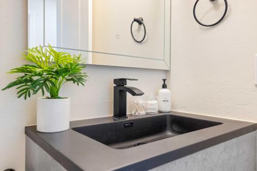 a kitchen sink with a faucet and a plant at #Marbella Lane - Cozy Gem Near Nature Trails in West Covina