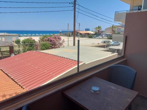 a balcony with a table and a view of a street at The Santo George Beach Resort in Amoudara Herakliou