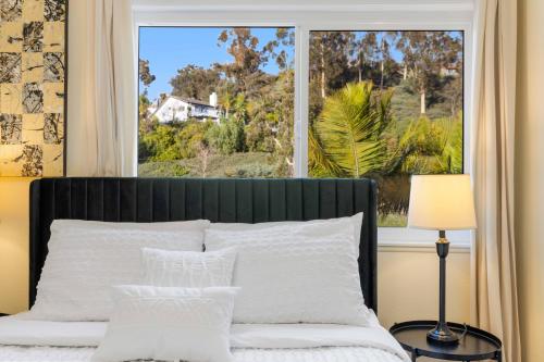 a bedroom with a bed with a large window at #Marbella Lane - Cozy Gem Near Nature Trails in West Covina