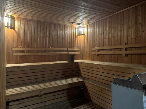 a sauna with wooden benches and lights in it at Grand Asoke Suites Boutique Residence in Bangkok