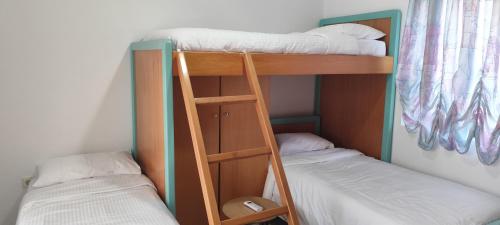 two bunk beds sitting next to each other in a room at Ioanna's Home in Émbonas