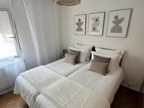 a white bedroom with a large white bed with pillows at Living Haro by Clabao in Haro