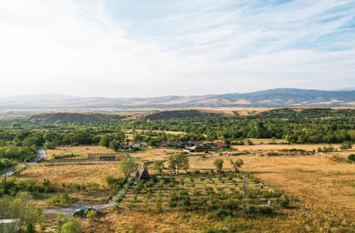 an aerial view of a farm in a field at Алпийска вила в полите Рила in Resilovo