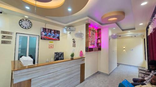 a waiting room with a clock on the wall at Hotel Ramayanam palace in Ayodhya