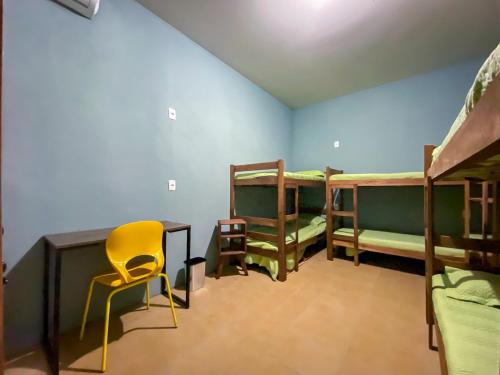 a room with three bunk beds and a desk and a chair at Maga Inn House - Centro in Blumenau