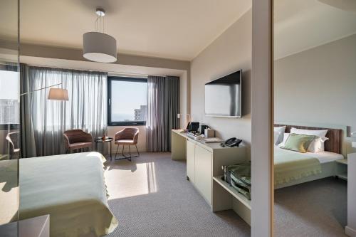 a hotel room with a bed and a desk at Millennium Hub & Hotel in Constanţa