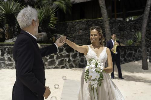 a bride and groom dancing on the beach at Royal Palm Beachcomber Luxury in Grand Baie