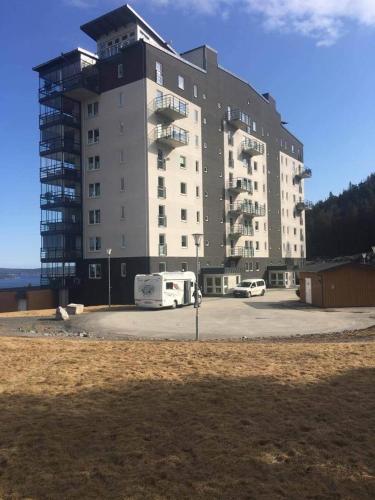 a large building with a bus parked in front of it at Exklusivt boende i Örnsköldsvik in Örnsköldsvik