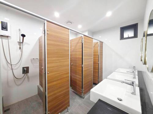 a bathroom with two sinks and a shower at Vintana Siam Bangkok Hotel in Bangkok