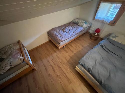 an overhead view of a bedroom with two beds at Historische Maisonettewohnung bis 10 Gäste, Magic Pass Belalp, Rosswald und mehr in Naters