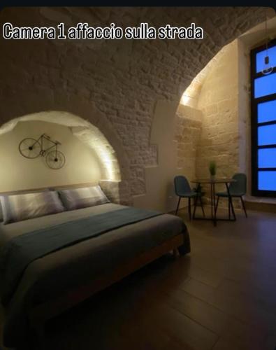a bedroom with a bed with a bike on the wall at Regina Bona Rooms in Modugno