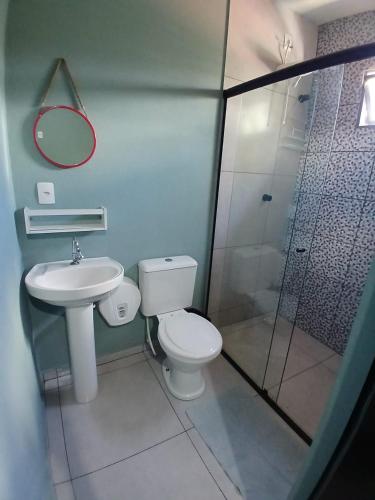 a bathroom with a toilet and a sink and a shower at Maga Inn House - Centro in Blumenau