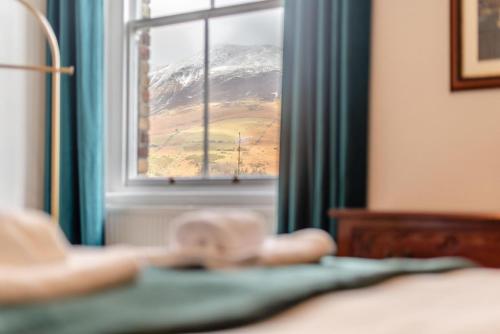 a window with a view of a snow covered mountain at Cameron Fell Apartment Keswick at The Lairbeck in Keswick