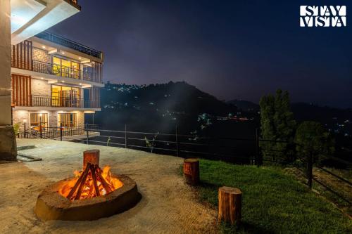 a fire pit in front of a building at night at StayVista at Kurinji Amaze Kodai with WiFI & Heater in Kodaikānāl