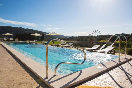 a swimming pool with a slide in a resort at Monnaber Nou Finca Hotel & Spa in Campanet