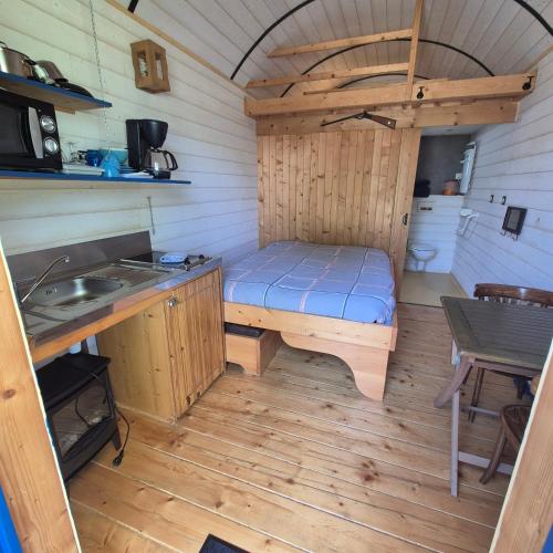 a small room with a bed and a sink at Etangs du Moulin in Suzy