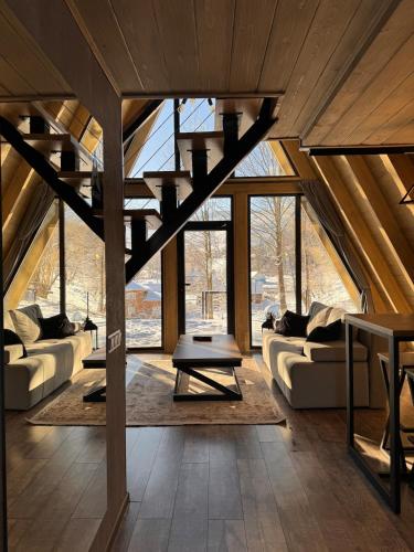 a living room with a staircase in a house at Grehit House in Kozmacz
