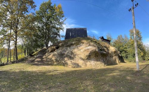 a large rock with a house on top of it at Grehit House in Kozmacz