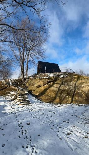 a house on a hill with footprints in the snow at Grehit House in Kozmacz