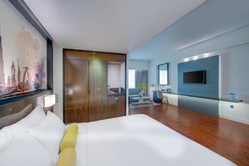 a hotel room with a bed and a television at Howard Johnson Plaza by Wyndham Dubai Deira in Dubai