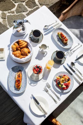 a white table with plates of food on it at Royal Palm Beachcomber Luxury in Grand Baie