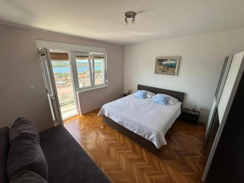a bedroom with a bed and a couch at Apartment Boni in Šibenik