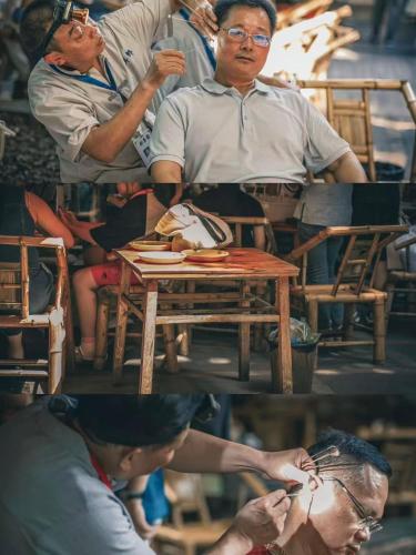 a group of people standing around a table at BuYuan Hotel - Near Wuhou Shrine, Chunxi Road,T aikooli, Tianfu Square, People's Park, Chengdu Museum, Very close to the Sichuan University , Exit C of Huaxiba on Metro Line 1,Provides Welcome refreshments ,Minibar,Laundry & Luggage delivery service in Chengdu