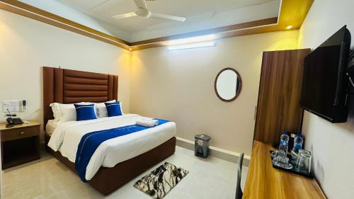 a bedroom with a bed and a flat screen tv at Hotel Blue Sky Dhaka Mirpur in Dhaka