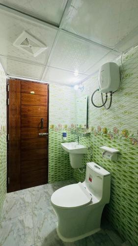 a bathroom with a toilet and a sink at Hotel Blue Sky Dhaka Mirpur in Dhaka