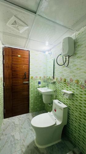 a bathroom with a toilet and a sink at Hotel Blue Sky Dhaka Mirpur in Dhaka