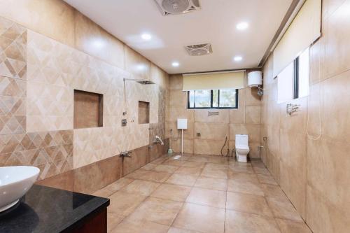a large bathroom with a toilet and a sink at Luxury 3-Bedroom villa with private swimming pool 