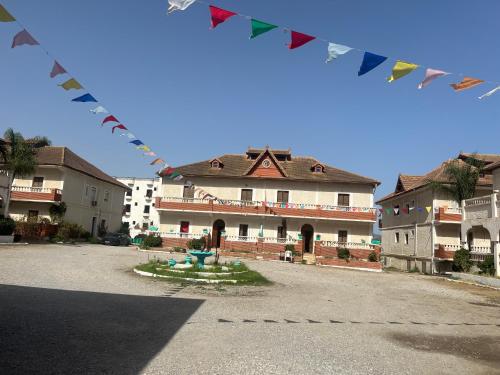 a building with flags in front of a courtyard at Diafet chatt 