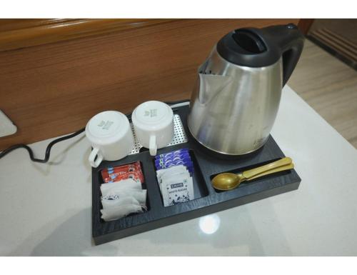 a table with a tea pot and some packets at Shri Ram Paying Guest House Premium Rooms in Varanasi