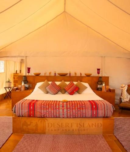 a bedroom with a bed in a tent at Desert Island Camp & Resort Jaisalmer in Jaisalmer