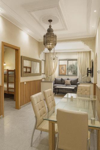 a living room with a couch and a table at SABOR FAMILY APARTS -Jaouharat Al Atlas in Marrakech