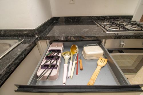 a kitchen counter with utensils on a tray at Zenitude in Casablanca