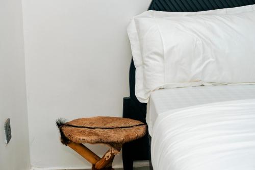 a bed with a wooden table next to a bed at Ndare Eco Ville in Kigali