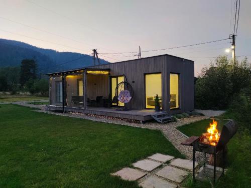 a small house with a fire in a yard at Barn S&S House in Mykulychyn