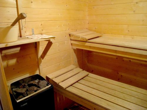 a wooden sauna with a bench and a trash can at Luxury Villa with Sauna in Francorchamps