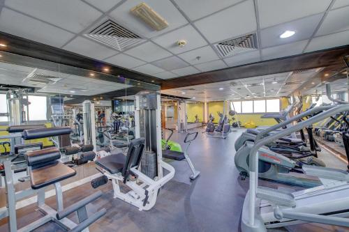 a gym with several treadmills and exercise bikes at Howard Johnson Plaza by Wyndham Dubai Deira in Dubai